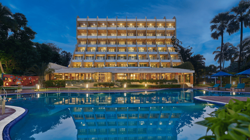 An overview of The Resort, Mumbai (Resort for Wedding Near Mumbai), during twilight showcasing the hotel facade and pool.