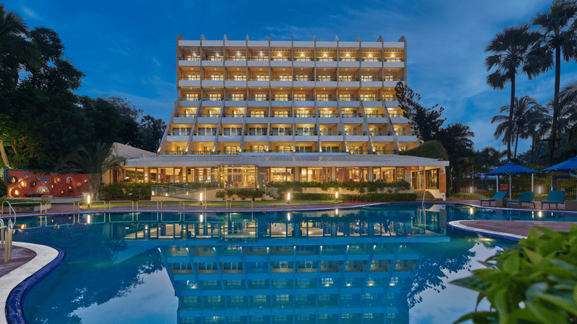 An overview of The Resort, Mumbai (Resort for Wedding Near Mumbai), during twilight showcasing the hotel facade and pool.