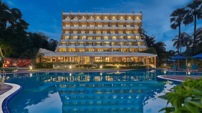 An overview of The Resort, Mumbai (Resort for Wedding Near Mumbai), during twilight showcasing the hotel facade and pool.