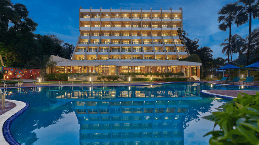 An overview of The Resort, Mumbai (Resort for Wedding Near Mumbai), during twilight showcasing the hotel facade and pool.