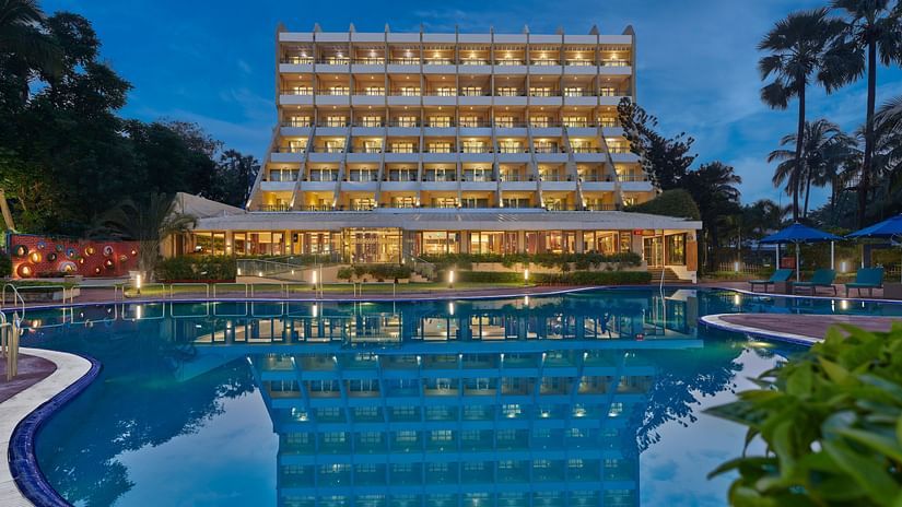 Night Image of The Resort, Mumbai, showcasing the hotel facade and pool.