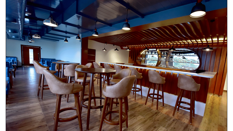 wide angle view of lotus bar with a bar counter and brown shade of furniture - Royal Lotus View Resotel2