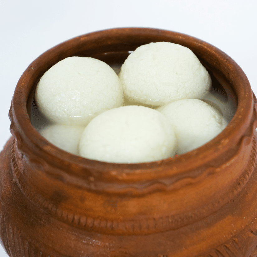 A brown clay pot holds aosogolla, a sweet famous in Kolkata.