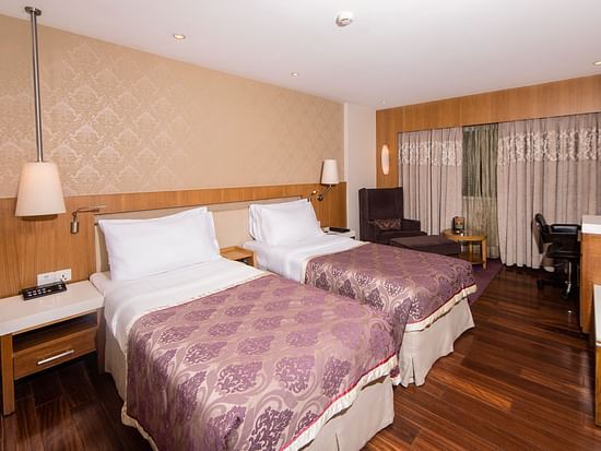 room with twin beds at hotel bawa international