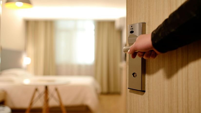 an image of an individual opening a room door 