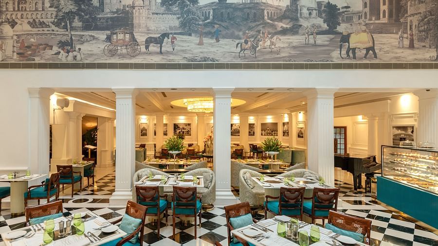 image of the lutyens deli multi cuisine restaurant with a beautiful painting at the top of the wall - The Claridges New Delhi
