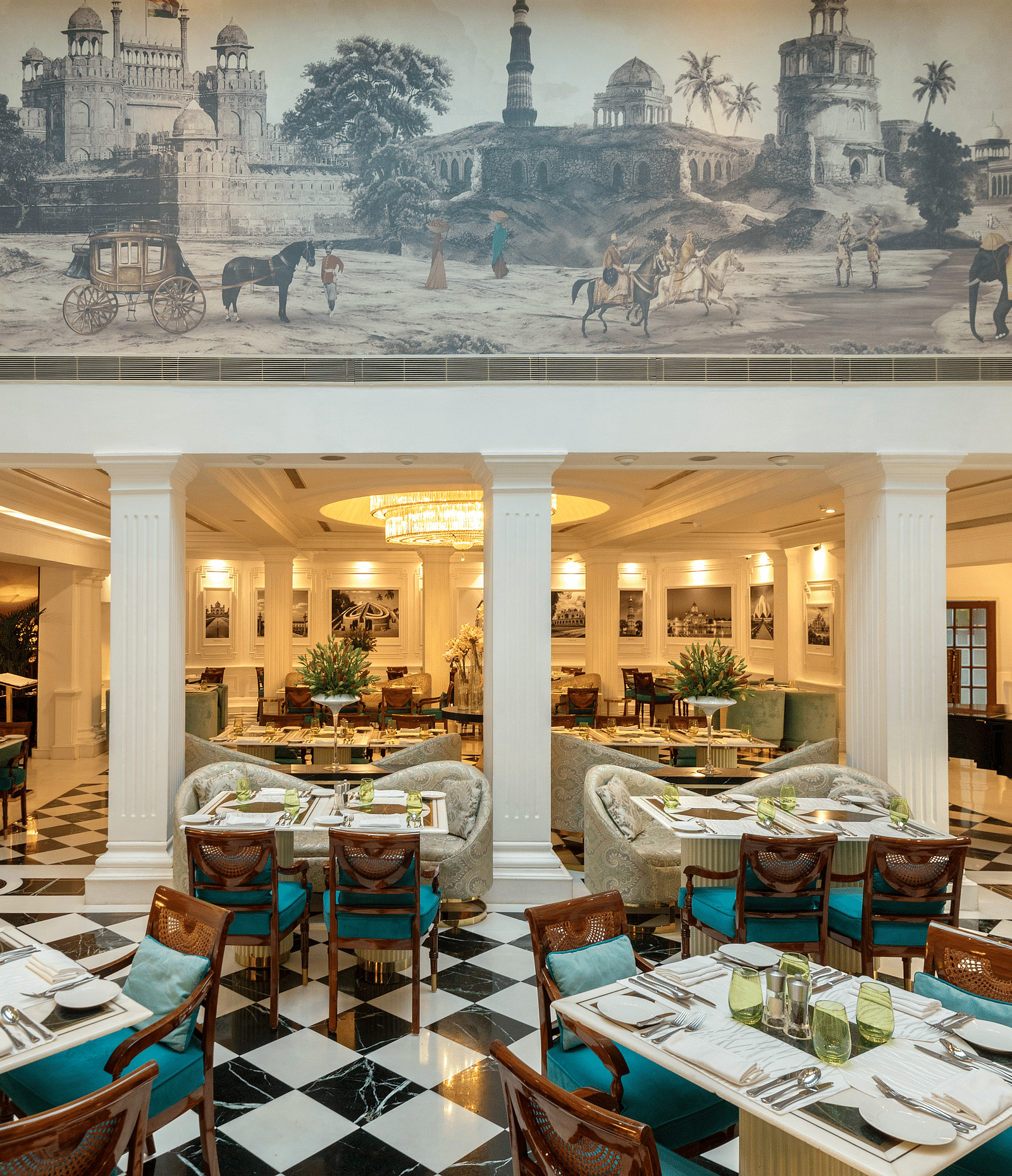 image of the lutyens deli multi cuisine restaurant with a beautiful painting at the top of the wall - The Claridges New Delhi