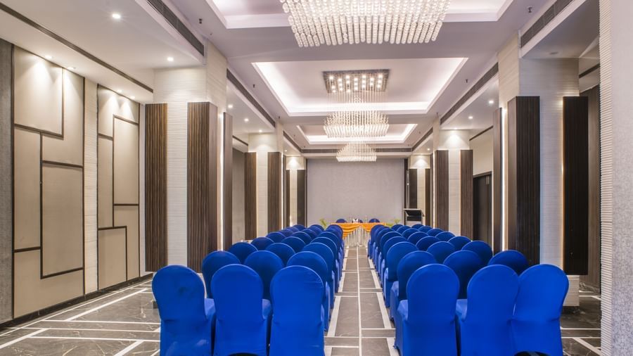 A meeting room setup with blue chairs at The Citi Residence Hotel, Asansol.