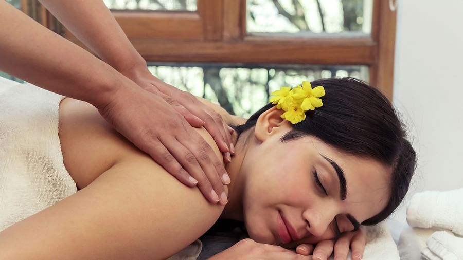 image of a woman enjoying a relaxing spa treatment at The Claridges Nabha Residence