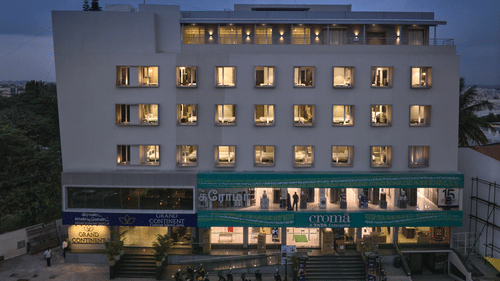 Facade view with all the lights on inside the hotel - Grand Continent - A Sarovar Premiere Affiliate Hotel, Hosur