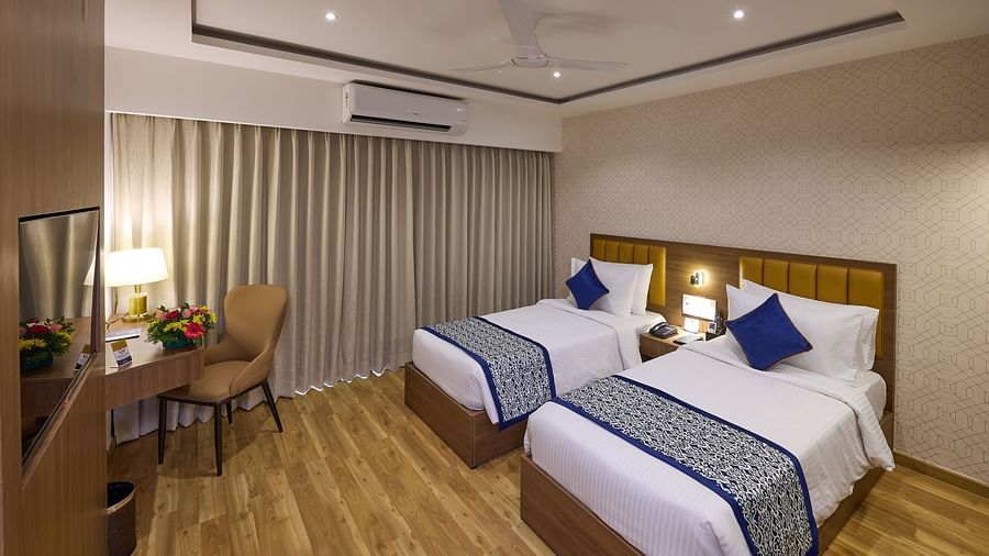 A cosy hotel room setup with two beds and a work desk - Grand Continent, Brookefield