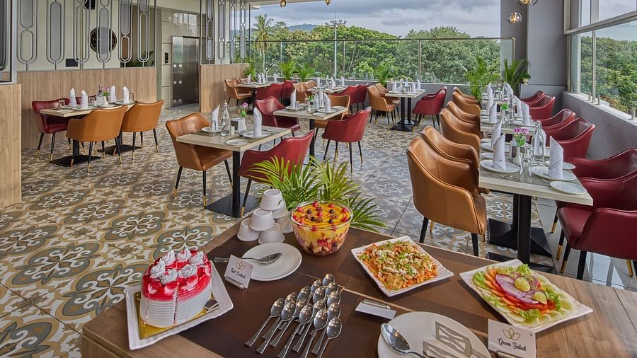 An image showcasing our restaurant with dishes on the front table and the dining area behind it
