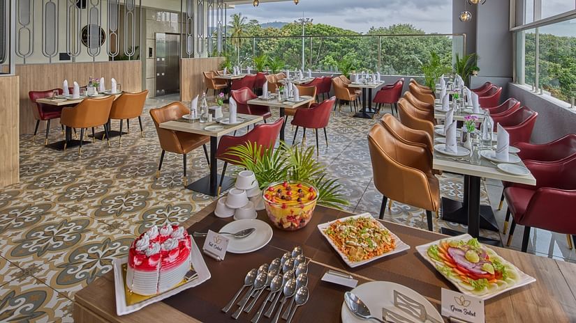 An image showcasing our restaurant with dishes on the front table and the dining area behind it