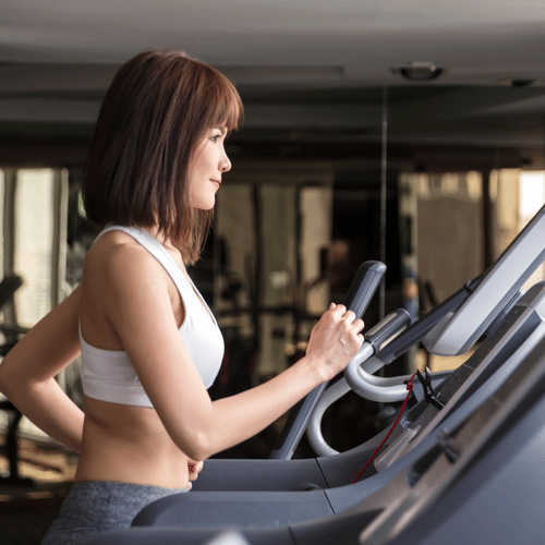 A woman running on a treadmill in a fitness centre