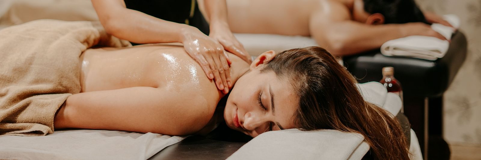 Two women giving back and shoulder massages to a couple at Crescent Spa & Resort, Indore