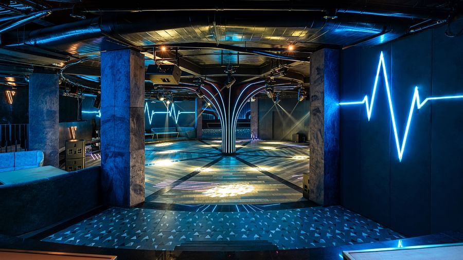 Verve showcasing a modern elevator interior with decorative lighting, mirrored walls, and a sleek design at The Qualia Resort Club & Brewery, Udaipur.