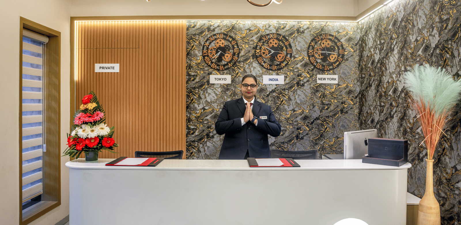 Elegant reception area with decorative wall art and welcoming front desk at Lords Studio Inn, Jamnagar.