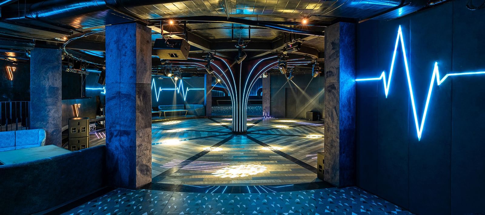 Verve showcasing a modern elevator interior with decorative lighting, mirrored walls, and a sleek design at The Qualia Resort Club & Brewery, Udaipur.
