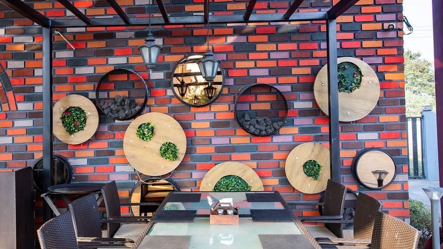 al fresco seating arrangements inside a restaurant - Wedlock Greens Hotel Resorts Dhanbad