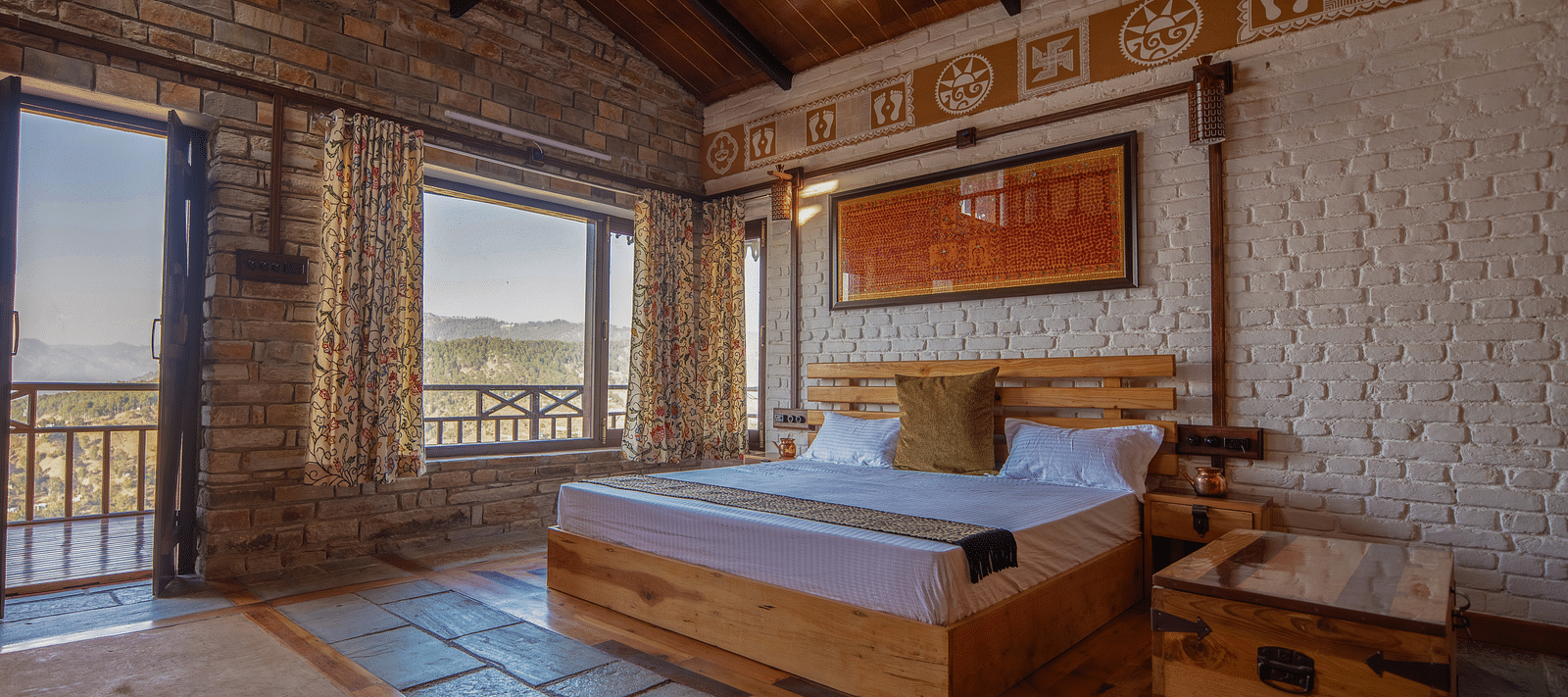 Room seating area with two wooden chairs, a rustic table, and a large window offering panoramic views of the lush mountains. - Blusalzz Homes The Himalayan Bungalow, Almora