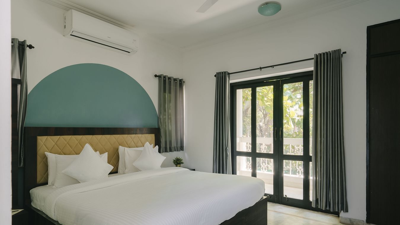 Open and airy bedroom with scenic outdoor views in the Three BHK Deluxe Villa at Richmonde Ananta Elite, Goa.