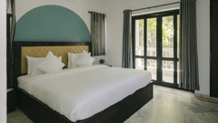 Open and airy bedroom with scenic outdoor views in the Three BHK Deluxe Villa at Richmonde Ananta Elite, Goa.