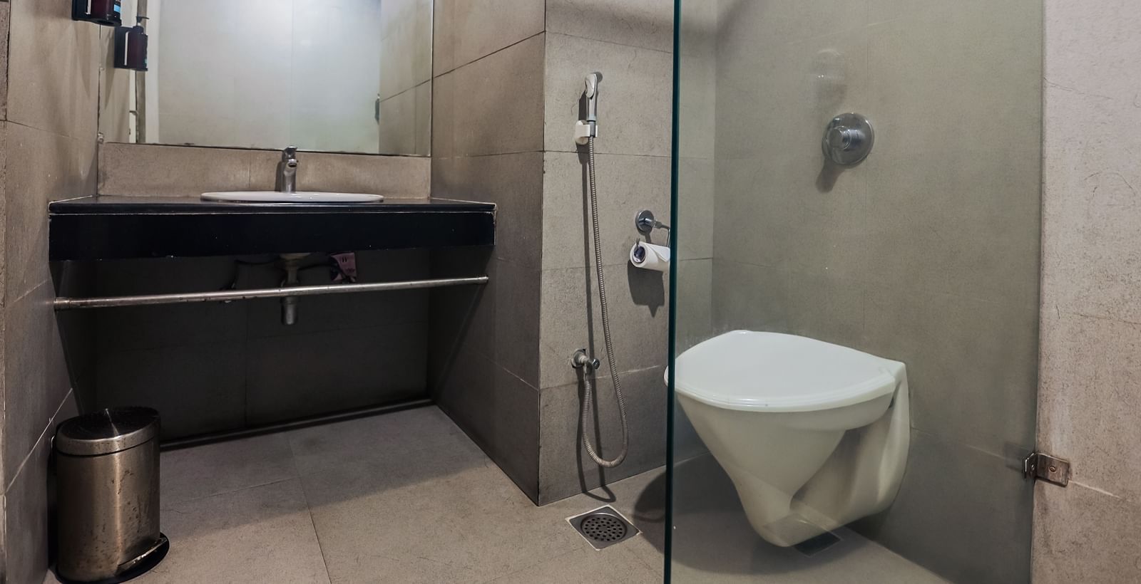 Clean bathroom with modern sink and mirror at Max Hotel Prayagraj.