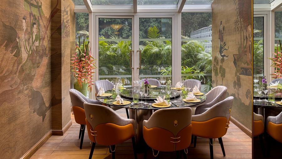  image of dining area with windos above and in front of it providing amazing dining experience at the claridges new delhi