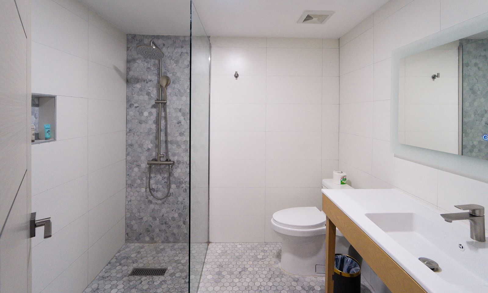 A spacious bathroom featuring a clean design with white tiles and a walk-in shower - Hotel 39, Jamaica