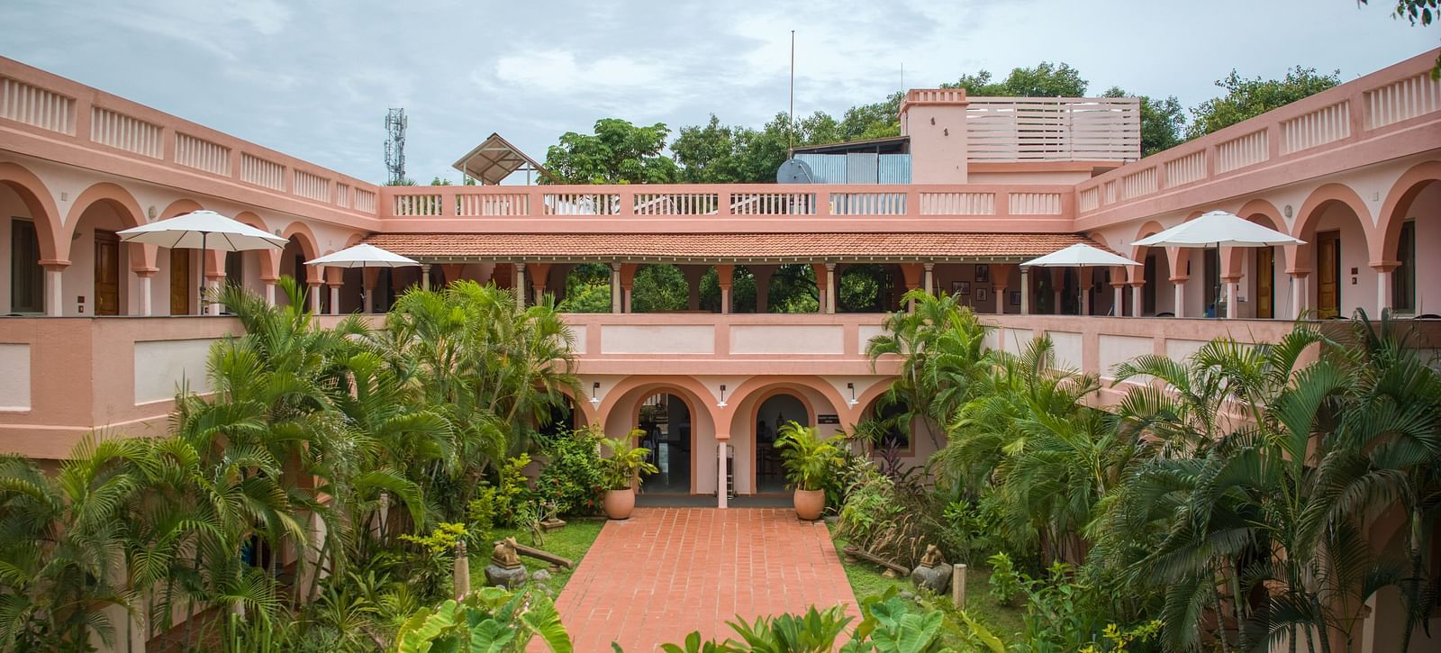 Resort property surrounded by greenery and various kinds of plants.