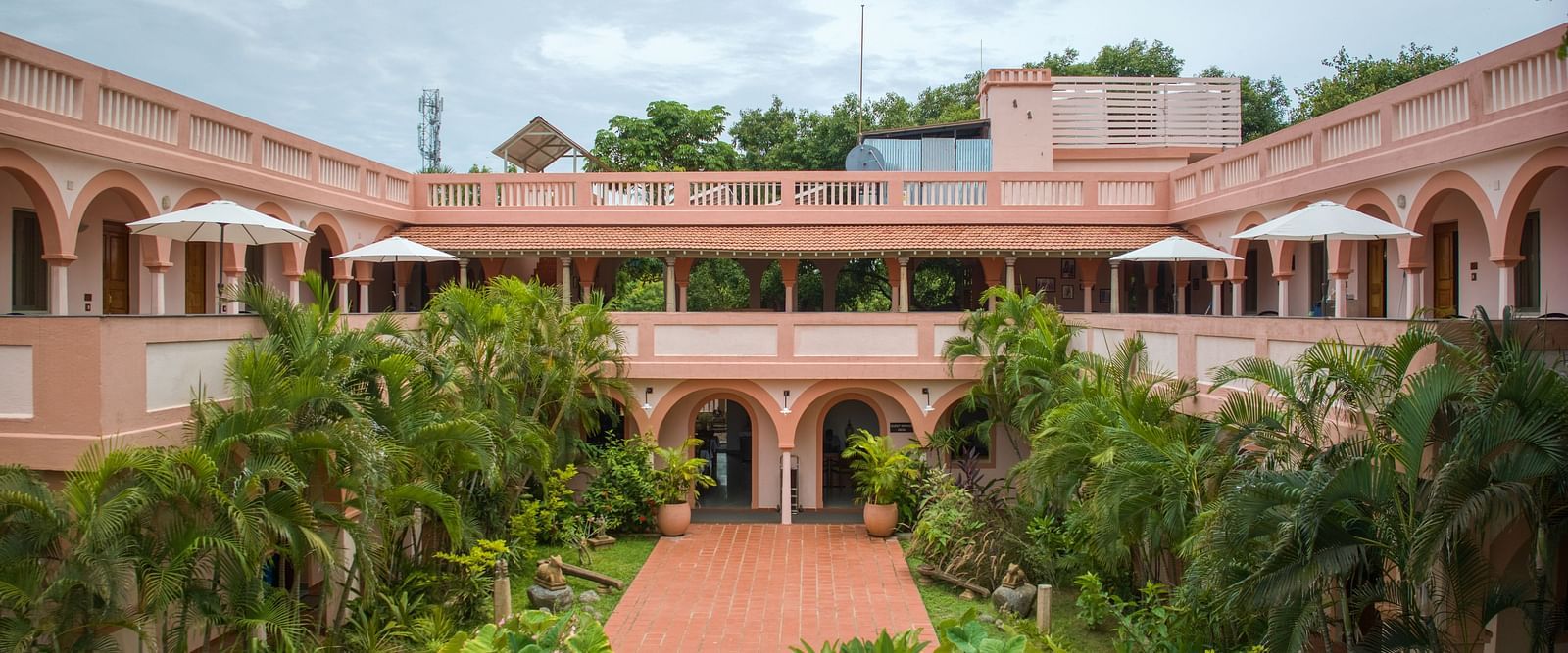 Resort property surrounded by greenery and various kinds of plants.