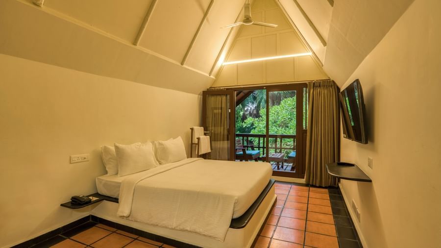 Thai Cottage Bedroom  with V shaped ceiling, a balcony and a bed.