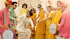 A vibrant group of people celebrating at an indian festival, dressed in colorful traditional attire, playing drums and dancing joyfully.