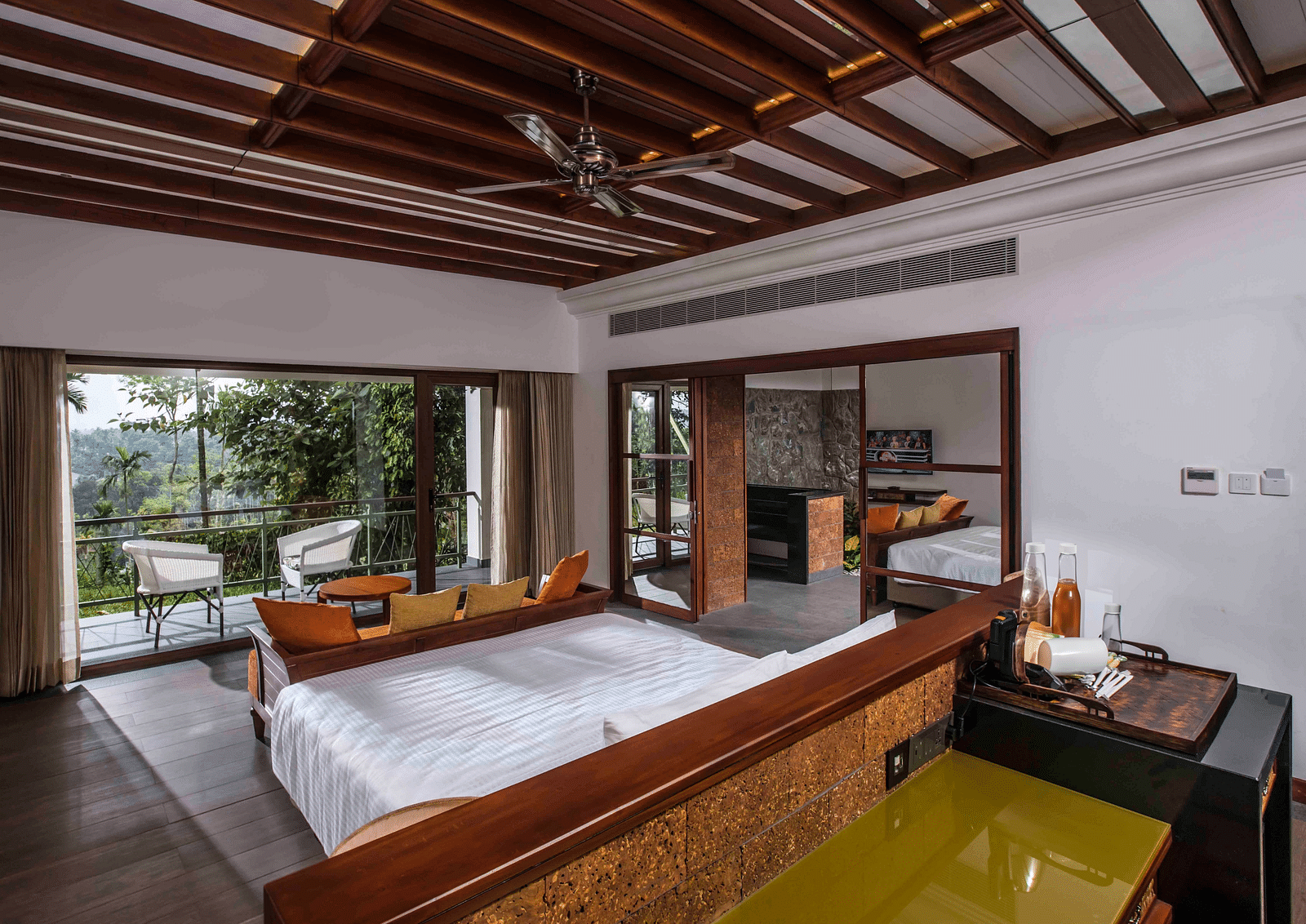 A room in Wayanad with a bed facing the beautiful view outside the room - GReaT trails Wayanad by GRT Hotels