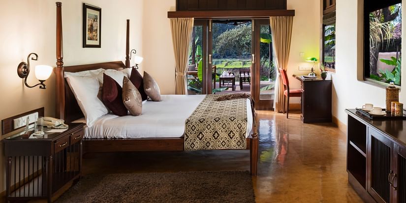 An image of Premium Room featuring a double size bed, a bedside table, a work desk and chair, a cabinet table, and a flat TV screen at Jehan Numa Restreat