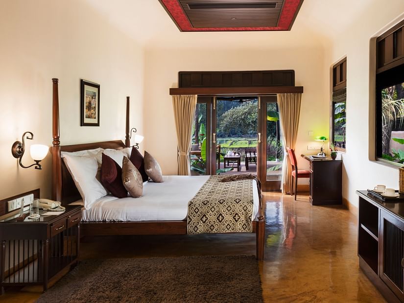 An image of Premium Room featuring a double size bed, a bedside table, a work desk and chair, a cabinet table, and a flat TV screen at Jehan Numa Restreat