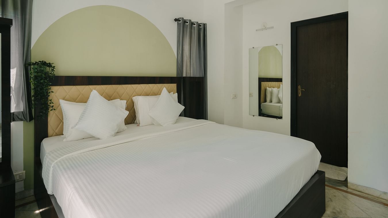 Spacious bedroom with a plush king-sized bed in the Three BHK Deluxe Villa at Richmonde Ananta Elite, Goa.