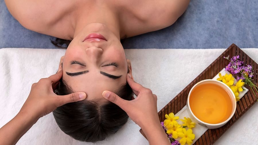 image of a woman getting head massage at The Claridges Nabha Residence