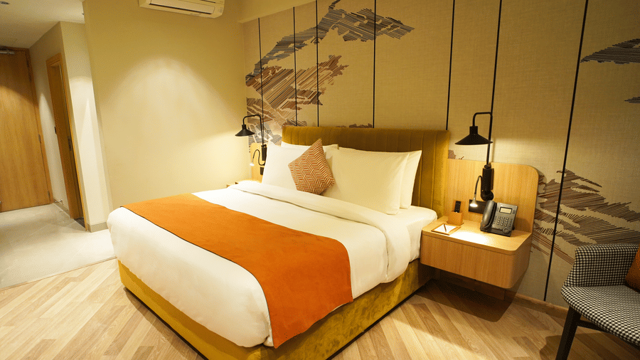 Cozy double bed setup in a modern room with accent lighting - Ramada Encore by Wyndham Gurugram Dwarka Expressway