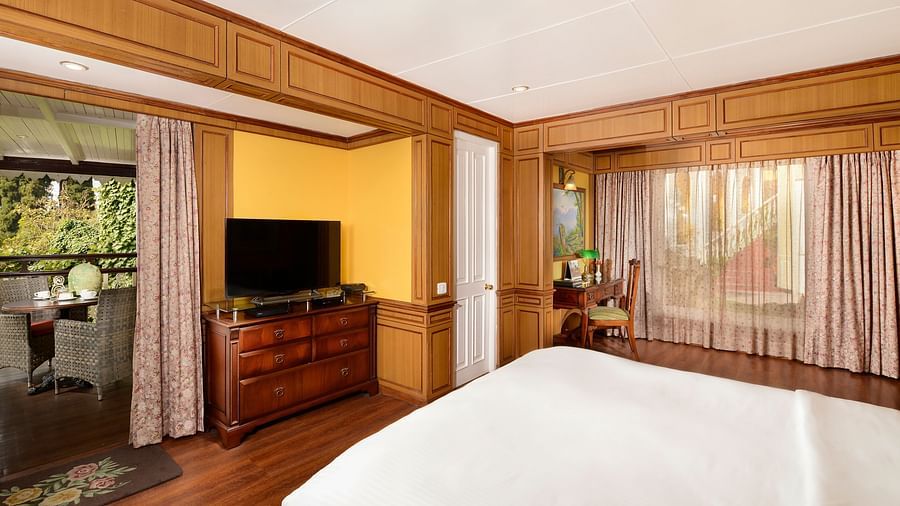 a king size bed and a tv - Mayfair Hill Resort, Darjeeling 2