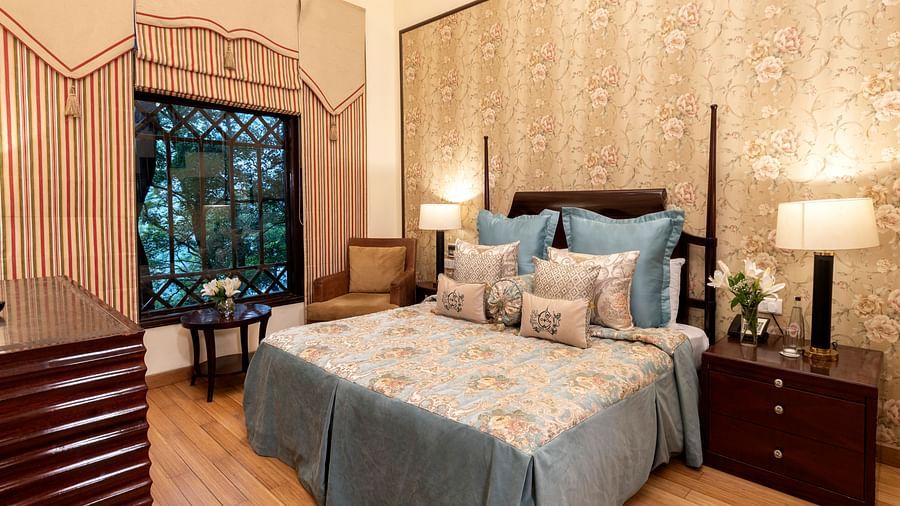 image of a king size bed with a window in Duplex Family Suite at The Claridges Nabha Residence