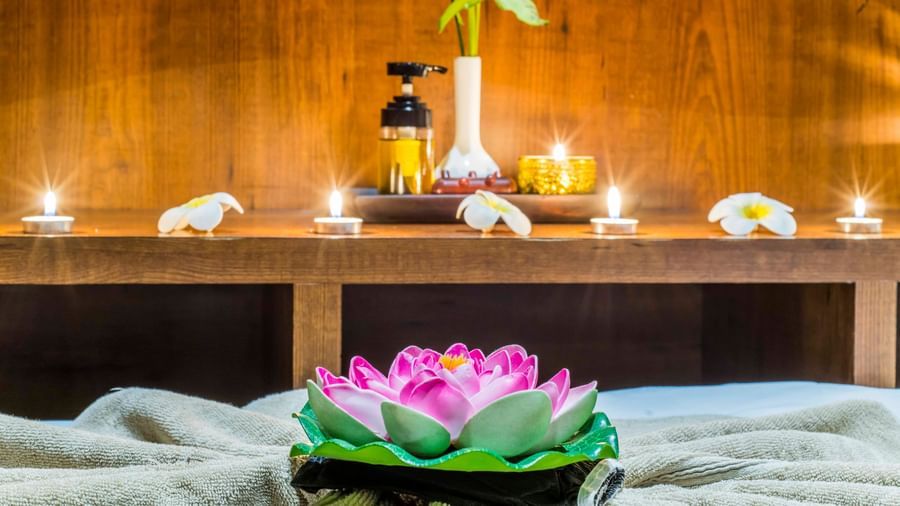 A spa or relaxation setting with flowers and candles at The Citi Residenci Hotel, Durgapur.