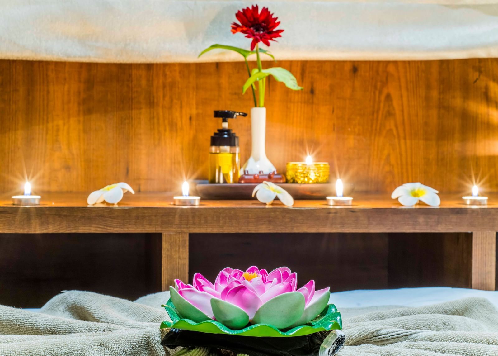 A spa or relaxation setting with flowers and candles at The Citi Residenci Hotel, Durgapur.