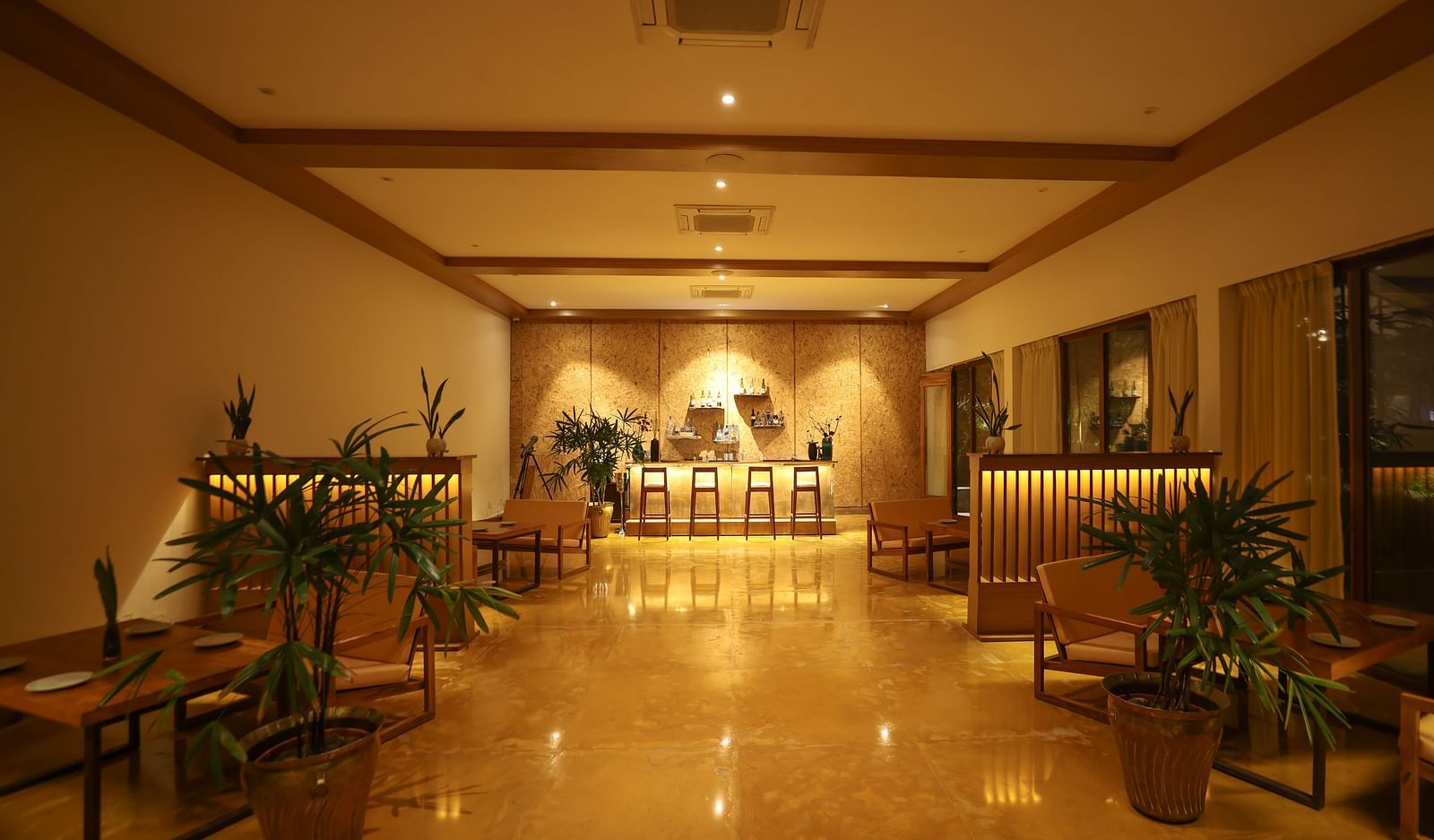 Interiors of the Saraca Bar at Saraca Resort & Spa Corbett with a warm ambience and indoor plants