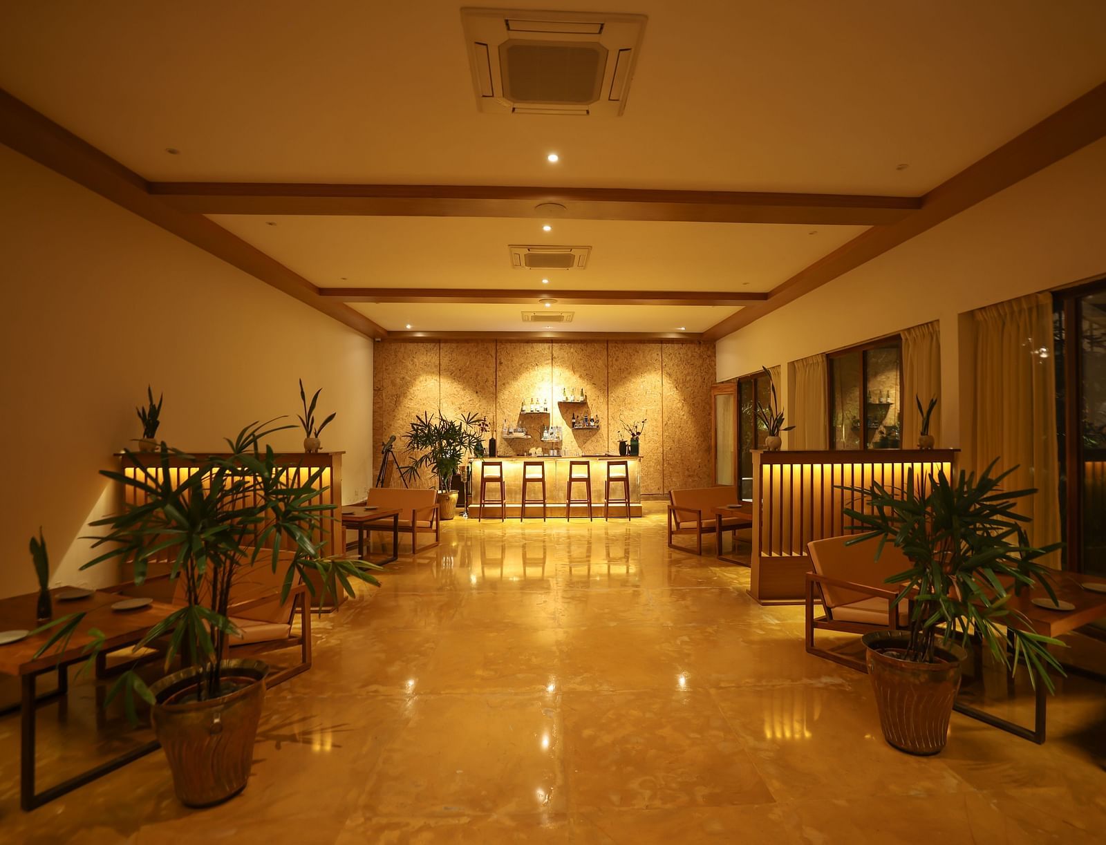 Interiors of the Saraca Bar at Saraca Resort & Spa Corbett with a warm ambience and indoor plants