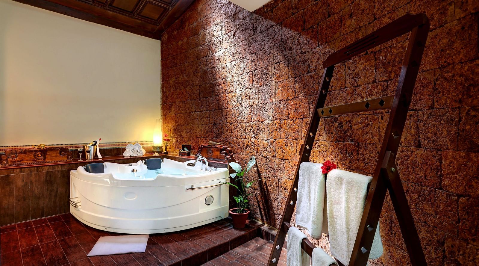 An image of a bathroom with bathing tub, and a cloth hanger - Hoysala Village Resort, Hassan
