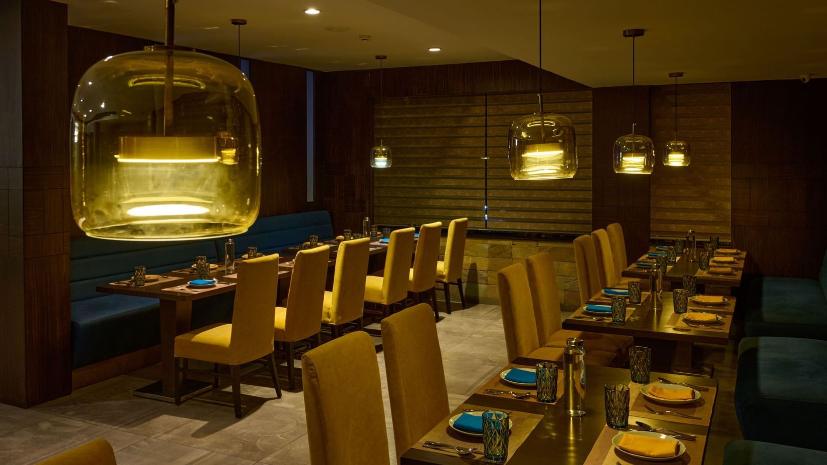 Elegant restaurant at Voyage Milestone Hotel and Banquet with hanging lights and cozy seating.