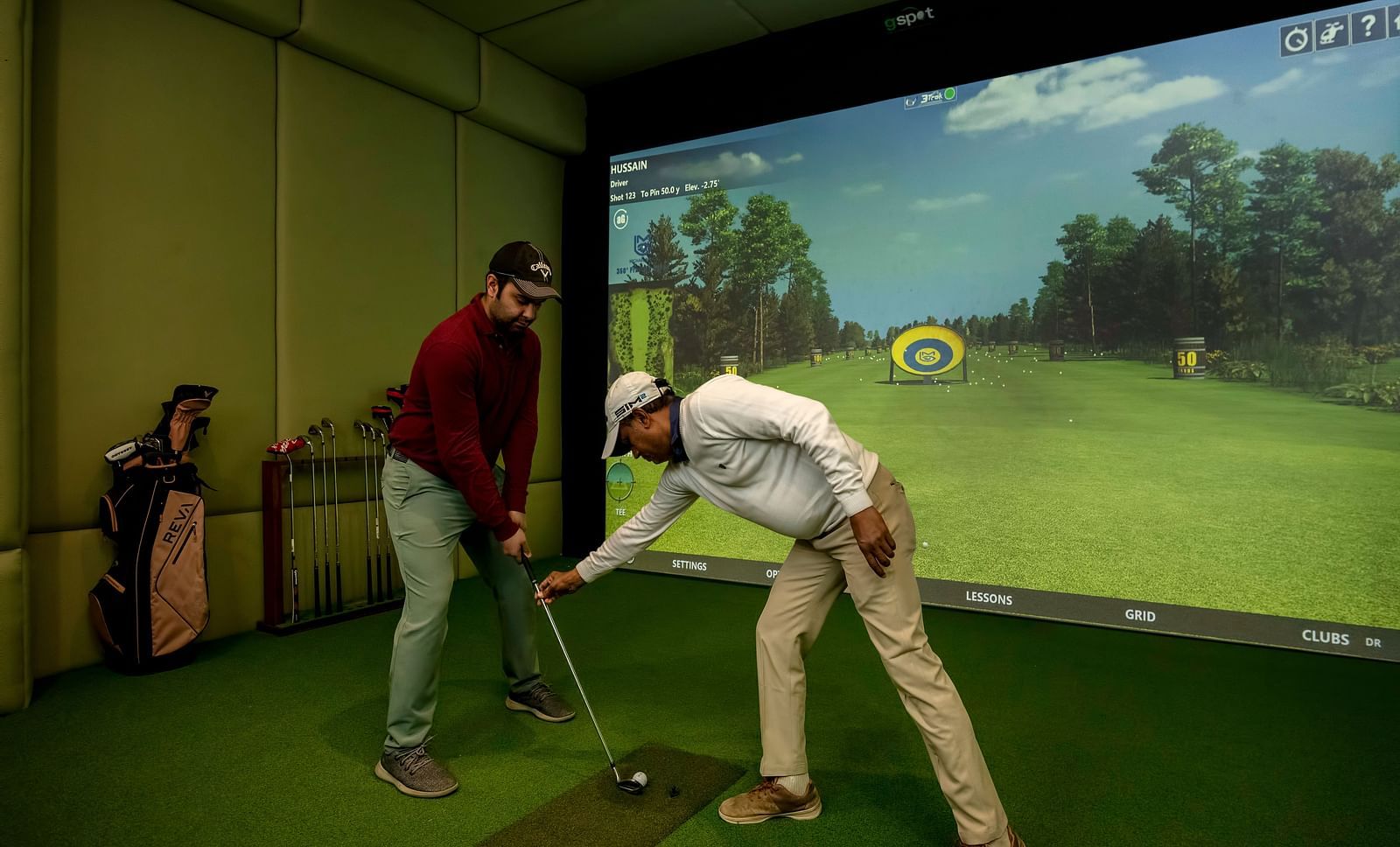 Two man playing the Golf simulator at The Claridges New Delhi