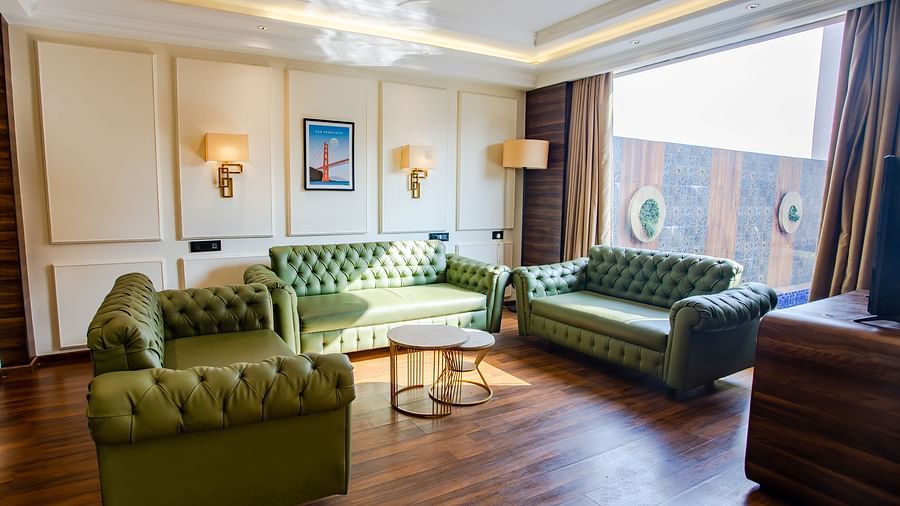 sofas with a table in centre and table in the centre - Wedlock Greens Hotel Resorts Dhanbad
