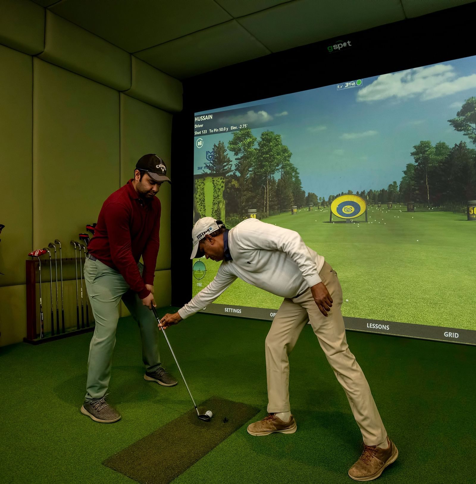 Two man playing the Golf simulator at The Claridges New Delhi